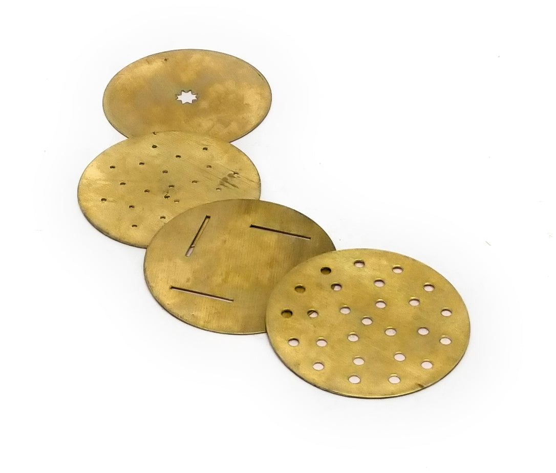 Four round brass filter discs with various hole patterns, arranged diagonally on a plain white background.
