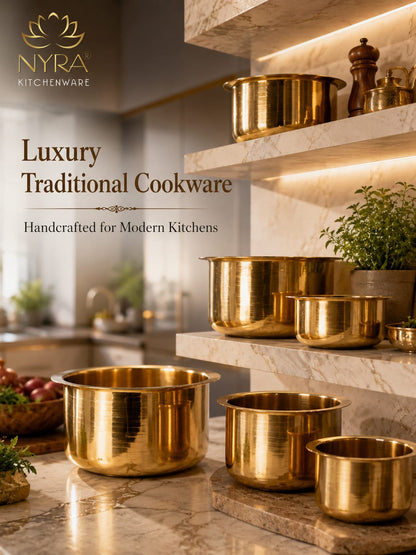 Gold cookware set on a marble shelf with 'Nyra Kitchenware' branding.