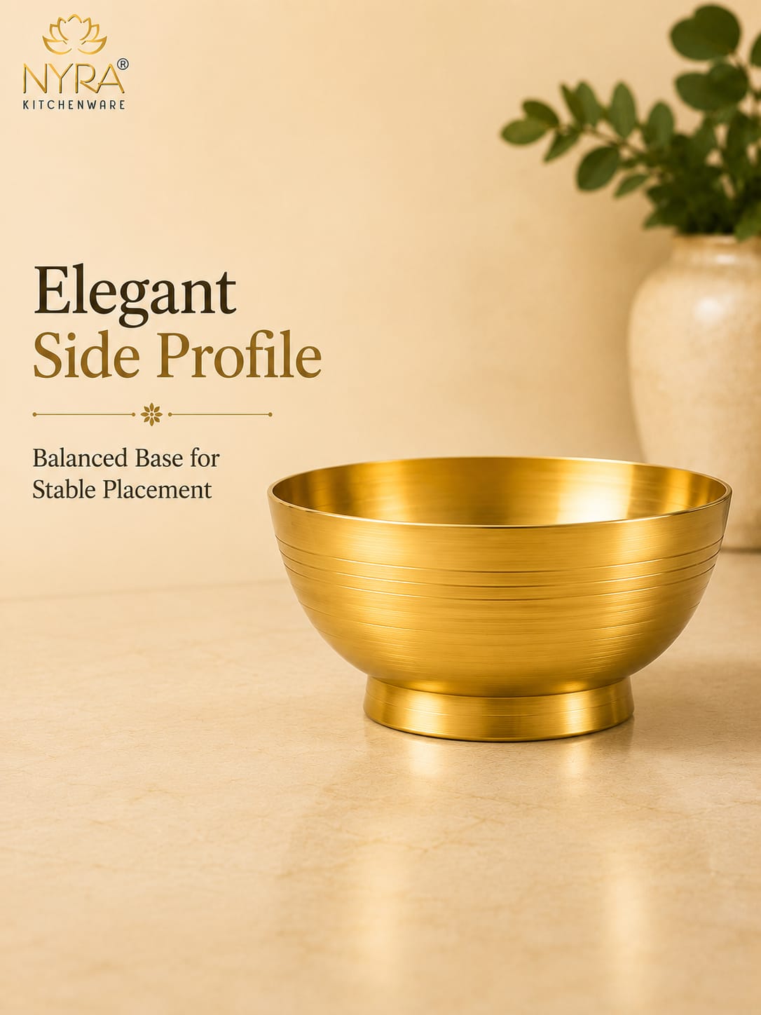 A gold-toned metal bowl shown from the side on a beige surface, with text reading 'Elegant Side Profile' and 'Balanced Base for Stable Placement.' The NYRA Kitchenware logo appears in the top left, and a blurred vase with greenery is in the background.