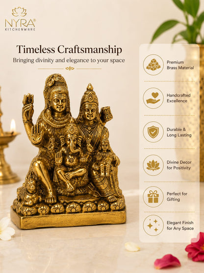 A brass-colored decorative statue of a Hindu deity family group on a pedestal, shown on a beige background with promotional text and feature callouts. The brand name NYRA KITCHENWARE is visible in the top left.