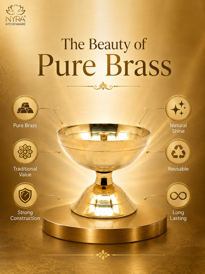 A golden brass pedestal bowl or chalice centered on a matching round base, with decorative text reading 'The Beauty of Pure Brass' and feature callouts around it including Pure Brass, Natural Shine, Traditional Value, Reusable, Strong Construction, and Long Lasting. The NYRA Kitchenware logo appears in the top left.