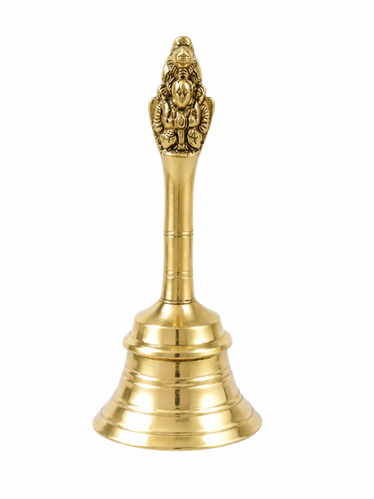 A polished brass bell with an ornate Ganesha figurine on its neck, set against a plain white background.