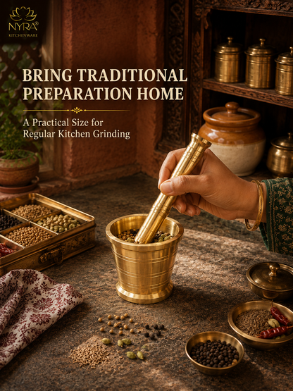 A brass mortar and pestle set in use on a stone surface, with a hand holding the pestle. The scene includes spices, jars, and shelves in a warm kitchen setting, with text reading 'BRING TRADITIONAL PREPARATION HOME' and a visible NYRA kitchenware logo.