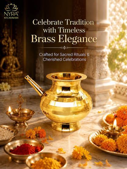 A polished brass pot (kumkura) displayed on a marble surface with traditional Indian ceremonial items including lit oil lamps, marigold flowers, and bowls of spices. The image features the NYRA Kitchenwide logo in the top left corner and promotional text overlay.