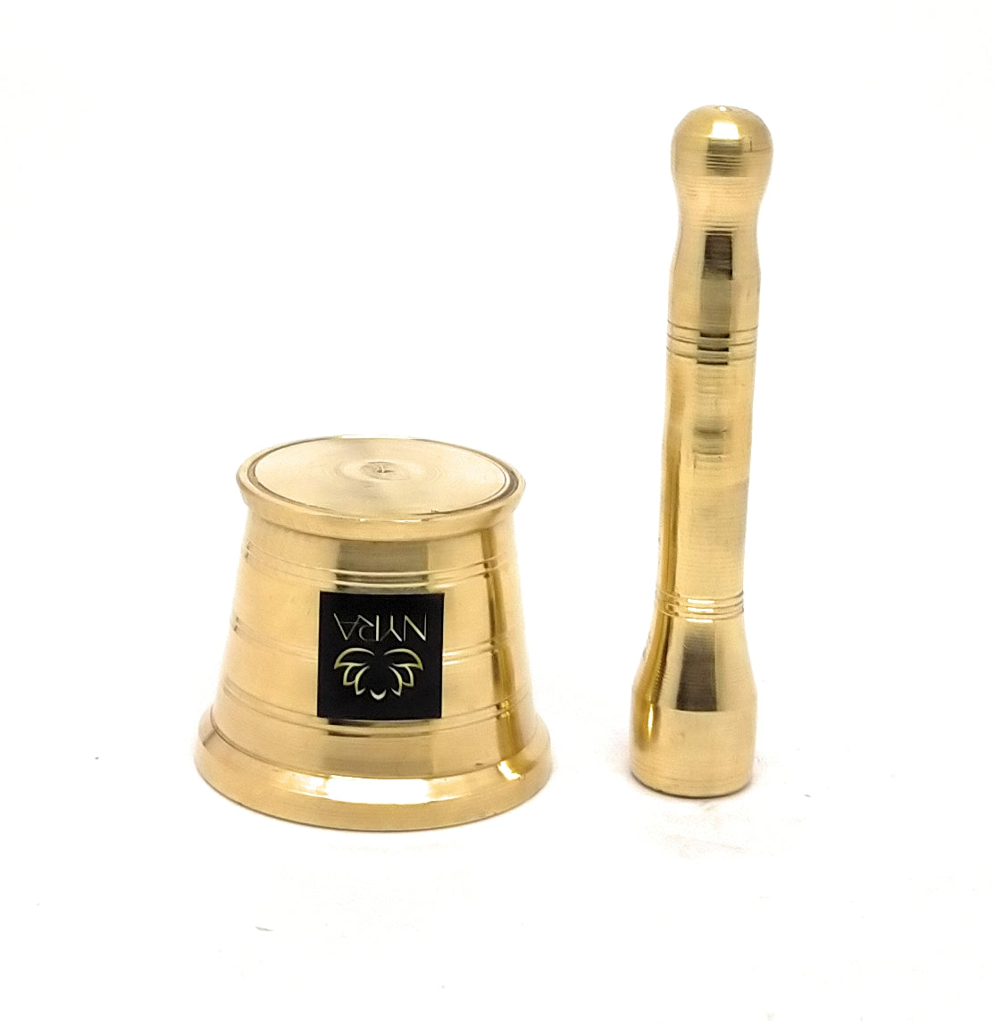 A polished brass temple bell and its matching mace (chakra) set, displayed on a clean white background. The bell features a black square label with the brand name 'VAKTU' and a stylized emblem.
