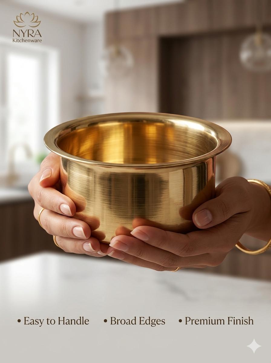 A pair of hands holding a polished brass bowl with a brushed metallic finish, set against a softly blurred kitchen background. The brand logo 'NYRA Kitchenware' is visible in the top left, and feature text at the bottom reads 'Easy to Handle', 'Broad Edges', and 'Premium Finish'.