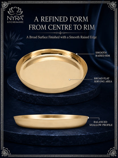 Gold-colored NYRA Kitchenware serving platter shown in two views on a dark navy background with text highlighting its smooth raised rim, broad flat serving area, and balanced shallow profile.