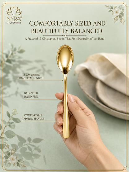 A gold-colored NYRA kitchenware spoon held by a hand, set against a soft sage green background with decorative floral elements and text highlighting its comfortable 15 cm size and balanced design.