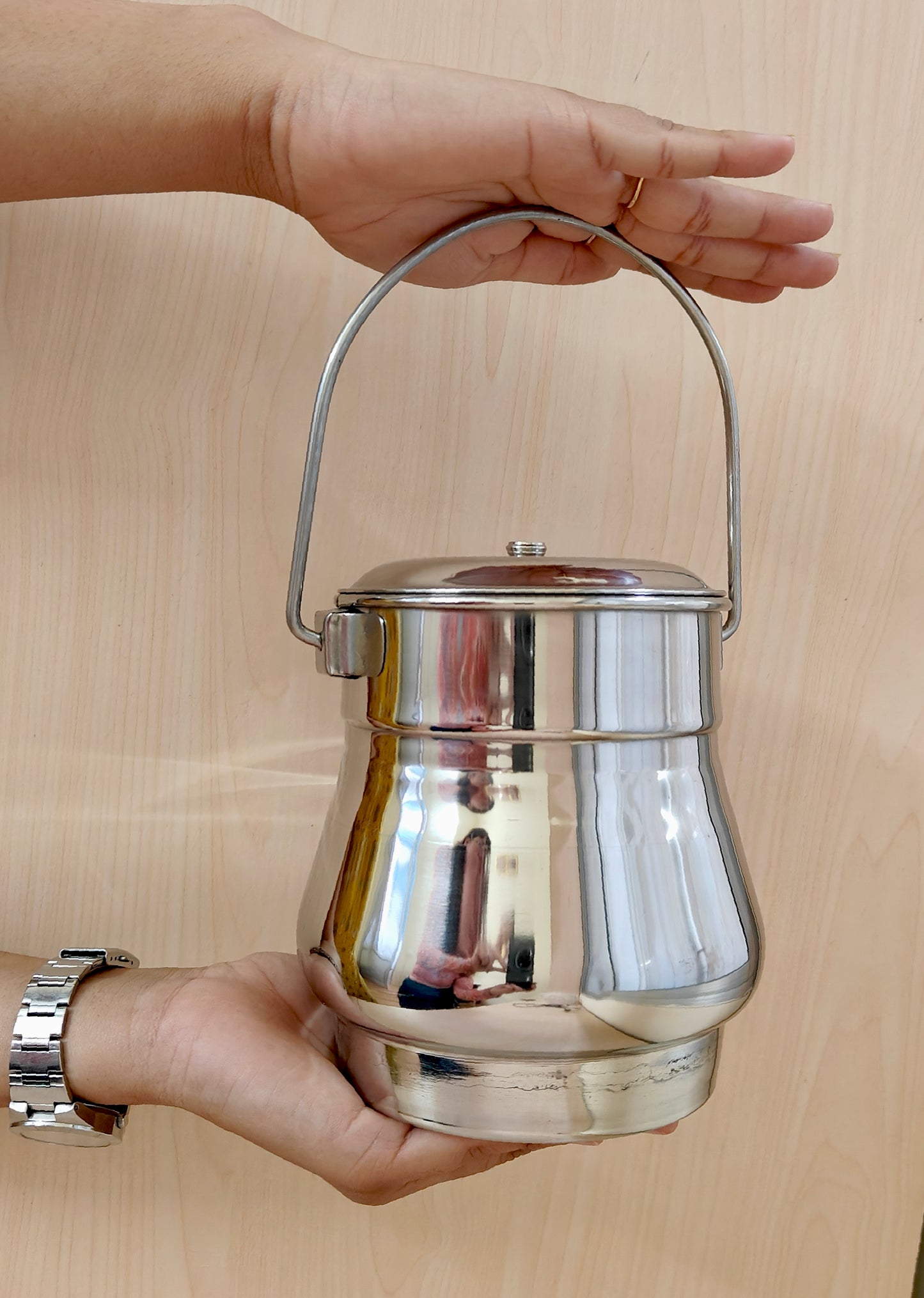 showing in hand Stainless Steel Milk Pot/Container with lid