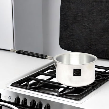 Silver pot on a gas stove with a black background