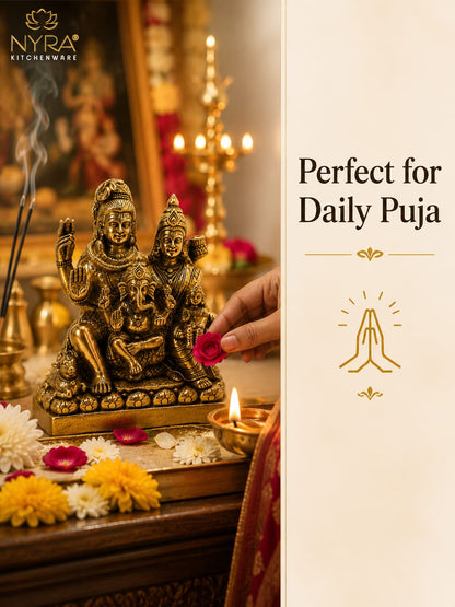 A brass Ganesha daily puja statue displayed on a wooden altar with flowers, incense, and a lit diya, alongside a cream-colored text panel on the right that reads 'Perfect for Daily Puja' with a praying hands icon. The NYRA Kitchenware logo is visible in the top left.