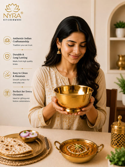 A woman in a beige embroidered kurta holds a polished brass bowl, with a matching brass plate and curry in the foreground. The image features a vertical text overlay on the left detailing the brand's authentic Indian craftsmanship and product benefits, set against a warm, softly lit dining room background.