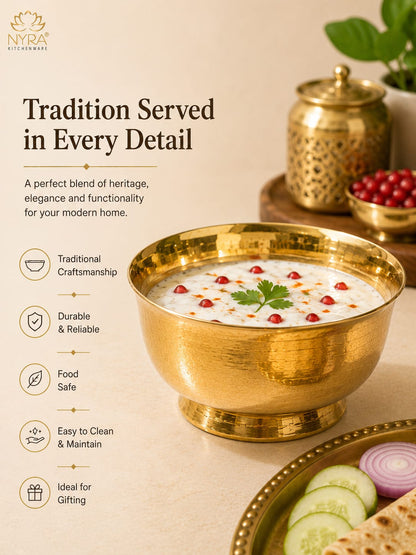 A gold-toned metal bowl filled with a white creamy dish topped with red garnish and a green herb sprig, set on a beige tabletop with decorative props including a brass jar, cucumber slices, and flatbread. Text on the left reads 'Tradition Served in Every Detail' with feature callouts, and the NYA brand logo appears in the top left.