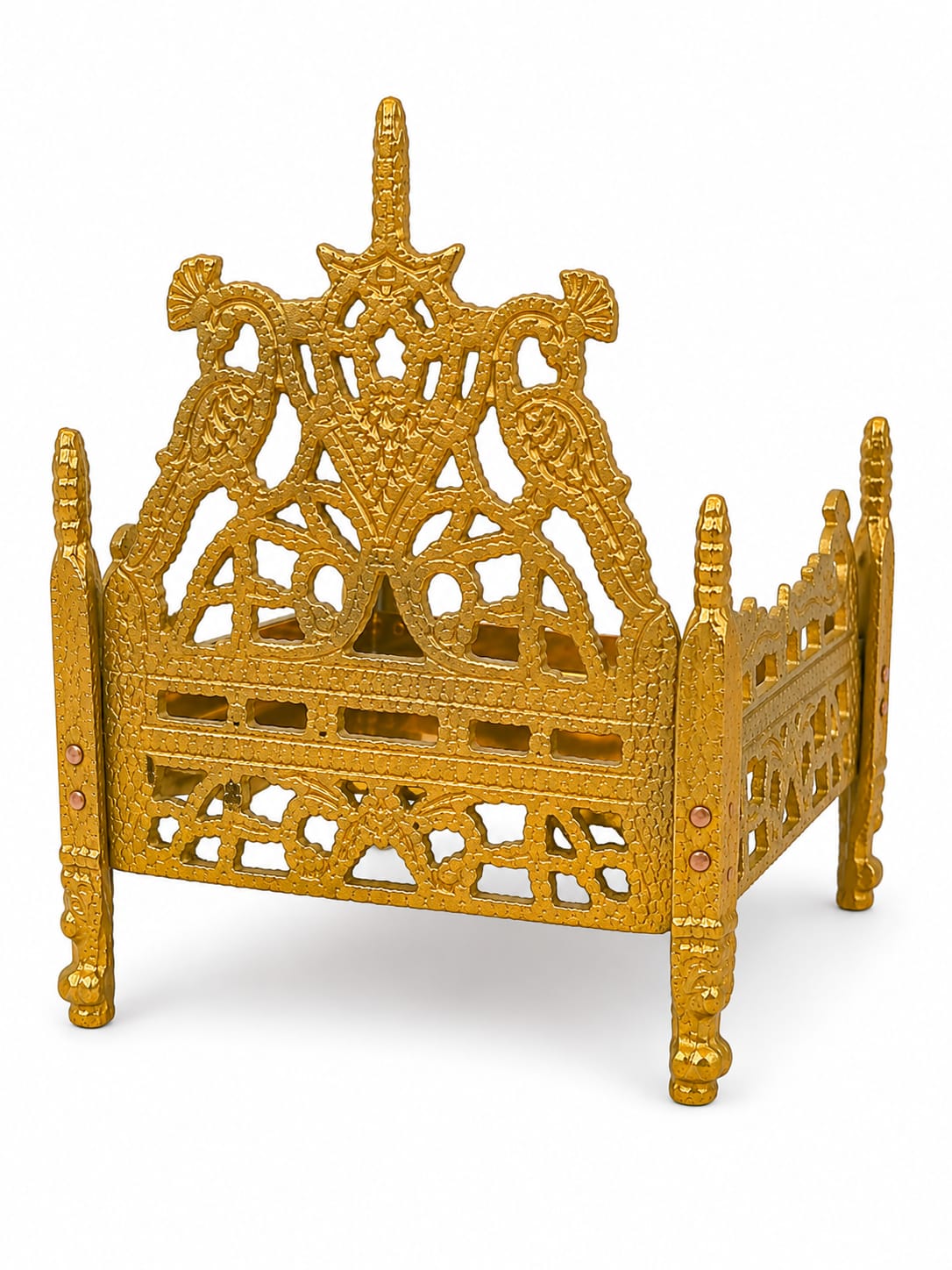 Decorative gold bed with intricate designs on a white background