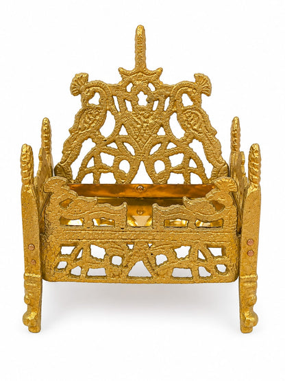 Decorative gold metal holder with intricate designs on a white background