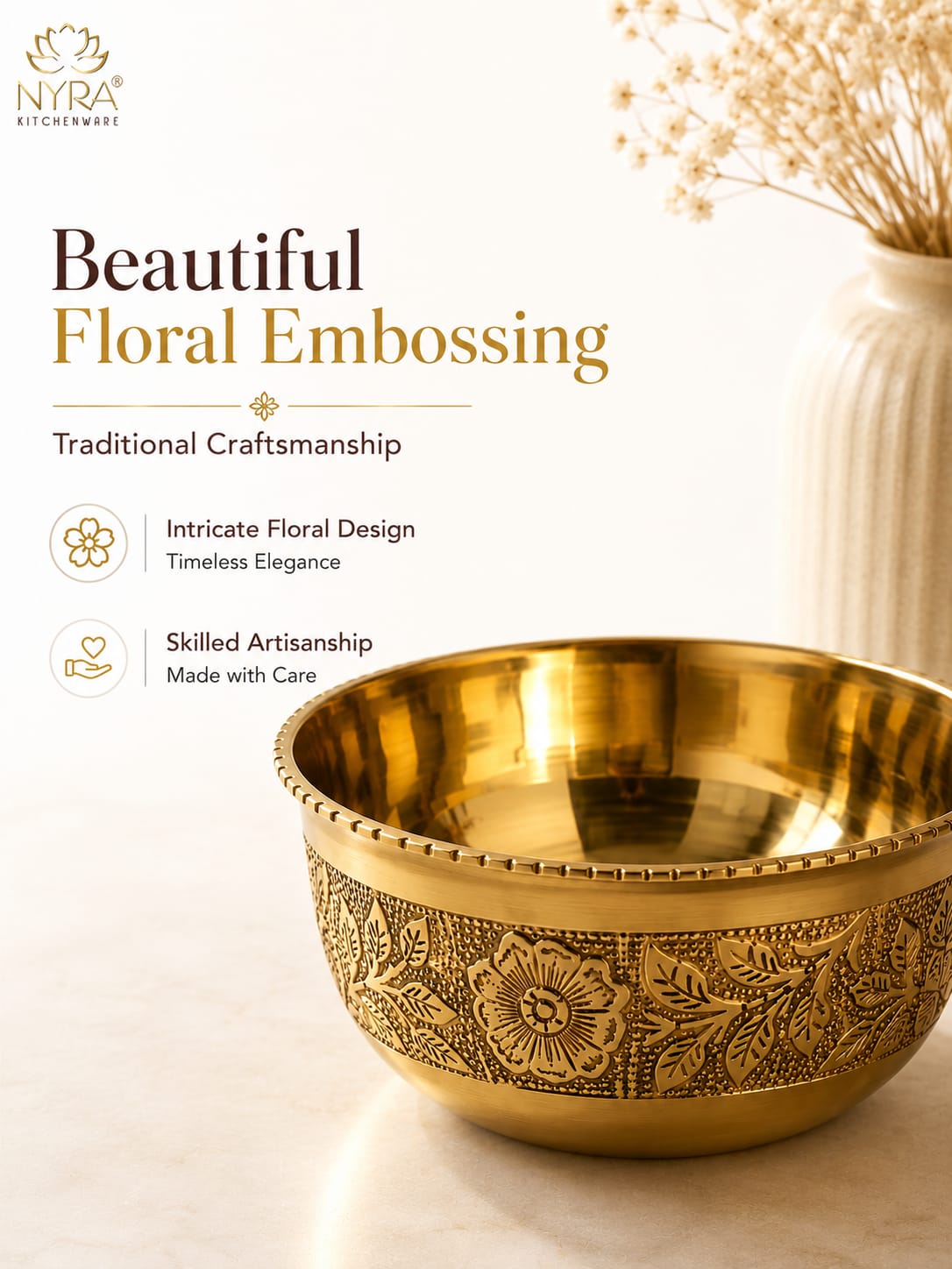A decorative brass bowl with floral embossing on the exterior, shown on a light beige surface with a white vase of dried flowers in the background. The image includes promotional text for 'Nyra Kitchenware' and the headline 'Beautiful Floral Embossing'.