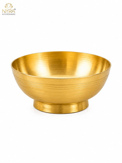 A round gold-colored metal bowl with a brushed metallic finish and a flared base, shown on a clean white background. The NYRA Kitchenware logo is visible in the top-left corner.