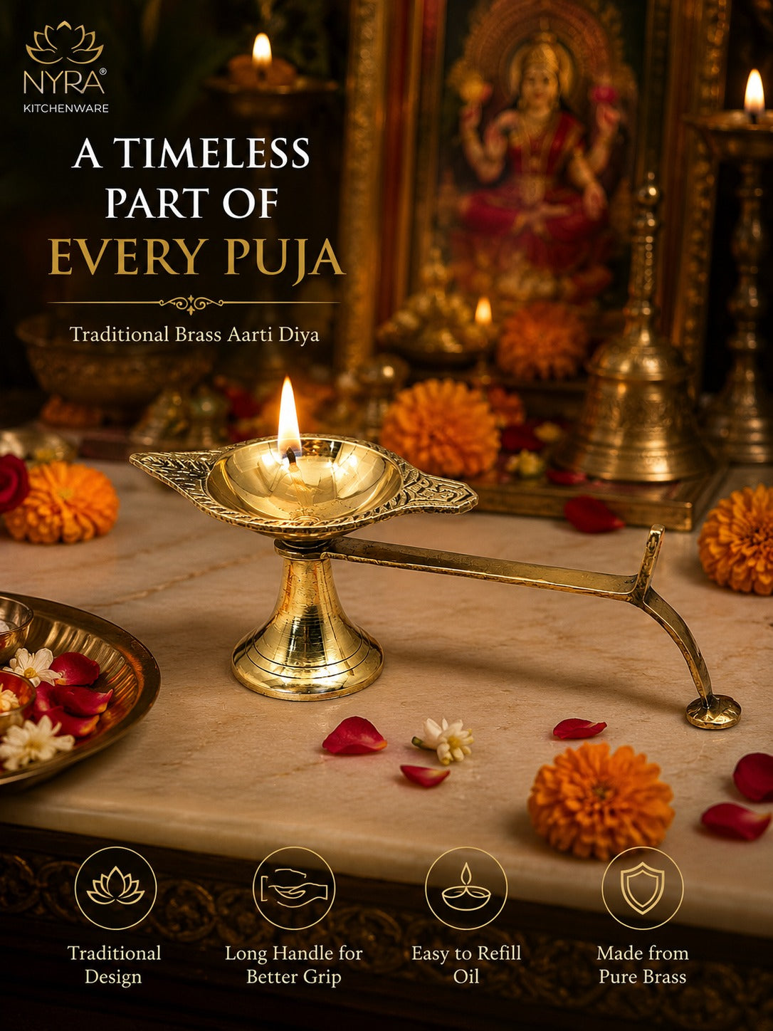 A brass Aarti diya oil lamp with a long handle, lit and set on a marble surface with marigold flowers and scattered petals, in front of a decorated puja altar. Text on the image reads 'A TIMELESS PART OF EVERY PUJA' and 'Traditional Brass Aarti Diya' with NYRA Kitchenware branding.