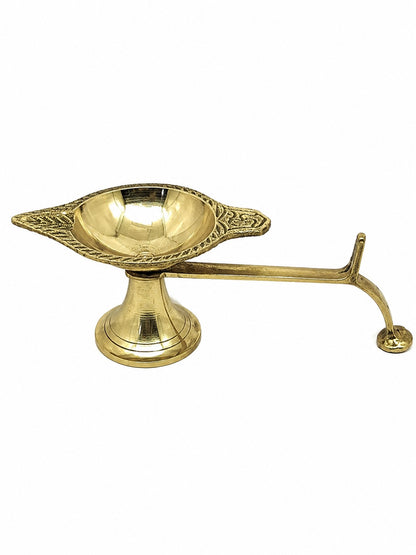 A brass oil lamp holder with a decorative leaf-shaped bowl and a curved handle, shown on a plain white background.