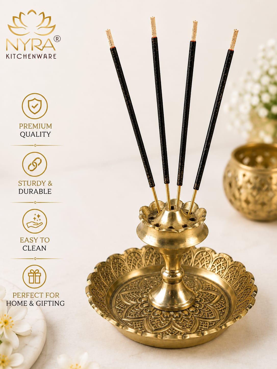A brass incense holder with five black incense sticks, shown on a light cream background with decorative flowers and a vertical feature list on the left. The brand logo 'NYRA KITCHENWARE' is visible in the top left.