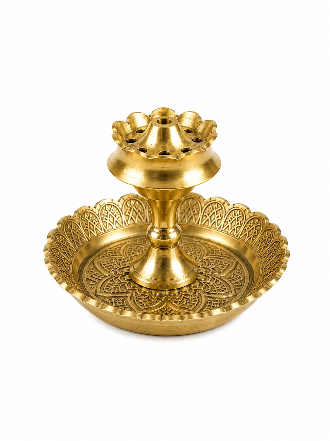 A golden brass double-tiered diya holder with intricate embossed patterns on the base and a scalloped rim, isolated on a white background.