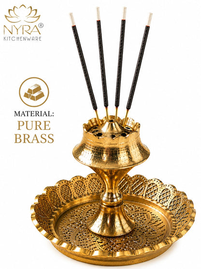 A gold brass incense holder set with five black incense sticks on a white background, featuring the NYRA Kitchenware logo and 'Material: Pure Brass' text.