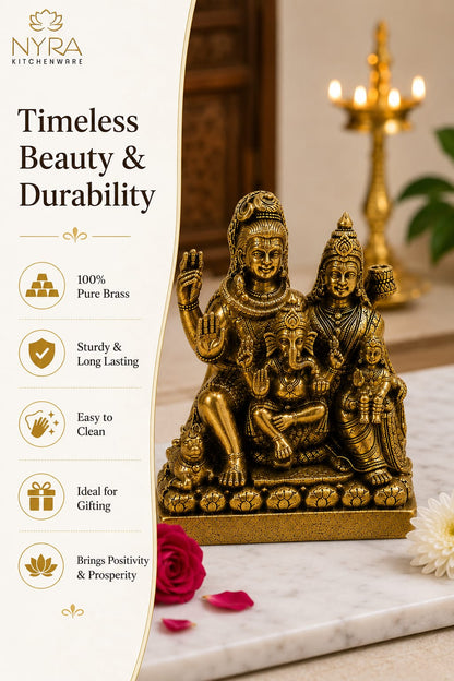 A brass statue of a Hindu deity family group displayed on a marble surface with a candelabra in the background. The left side features a promotional banner with text and icons for 'Nyra Kitchenware' highlighting product features like '100% Pure Brass', 'Sturdy & Long Lasting', and 'Easy to Clean'.