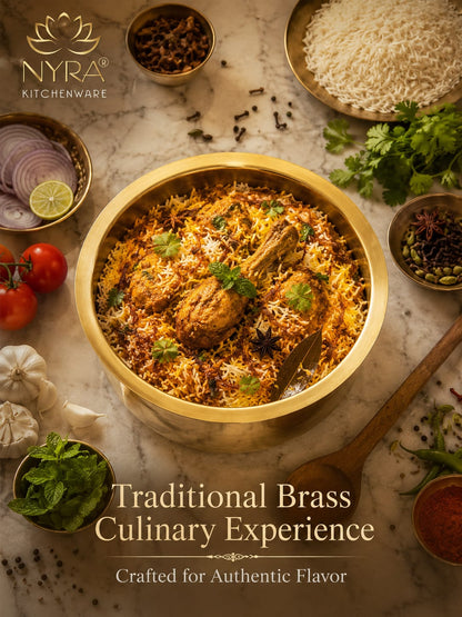 Traditional brass dish with food on a marble surface, featuring Nyra Kitchenware branding.