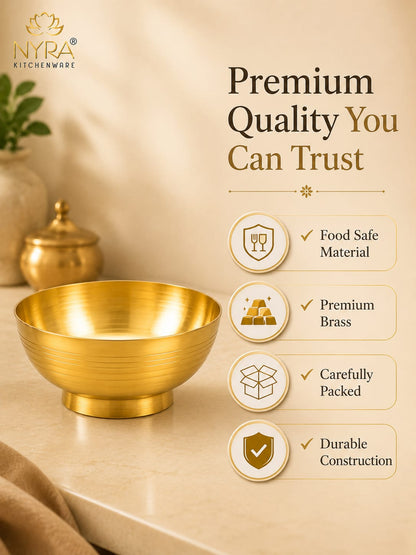 A gold brass bowl by INYRA Kitchenware on a beige countertop, with promotional text and feature icons on the right side. The image highlights food-safe material, premium brass, careful packing, and durable construction.