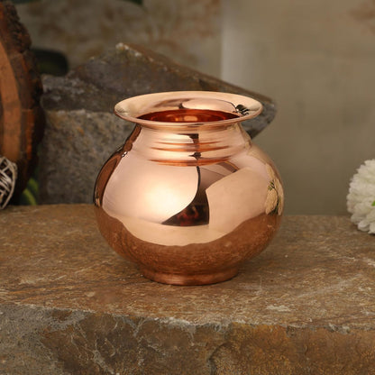 Copper vase on a stone surface with a blurred natural background