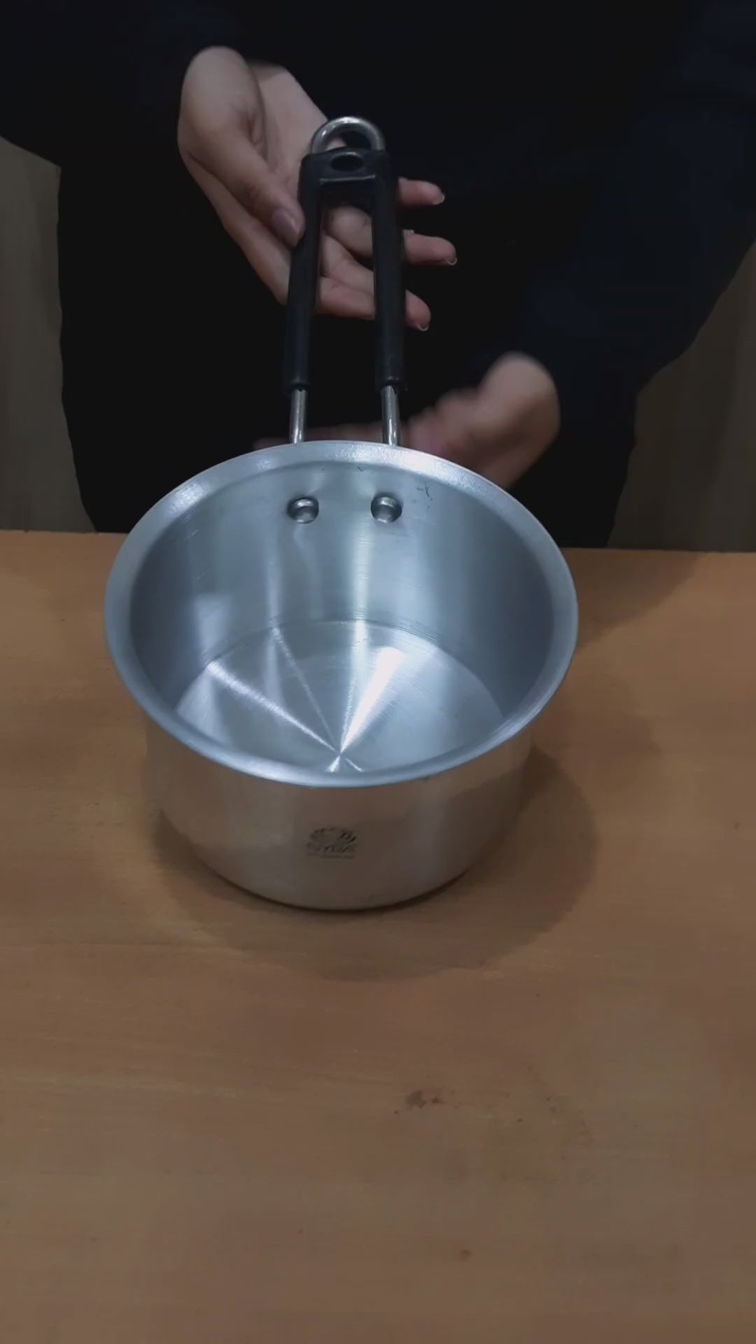 showing in hand aluminium Saucepan